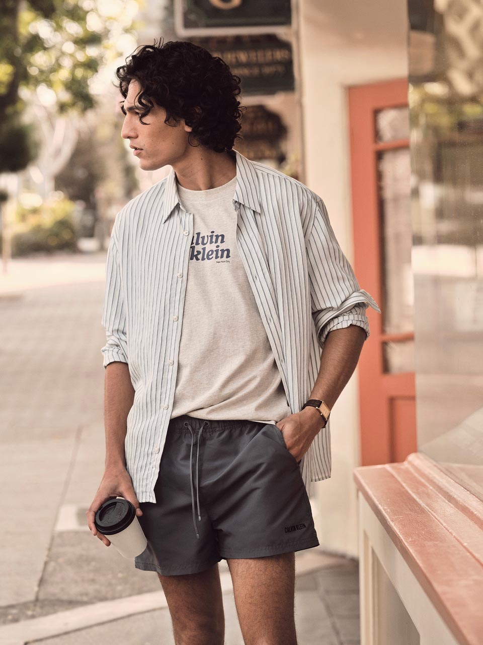 Model posing in a white logo tee